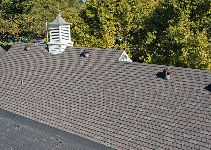 Steep-slope shingle roof with cupola on an institutional building
