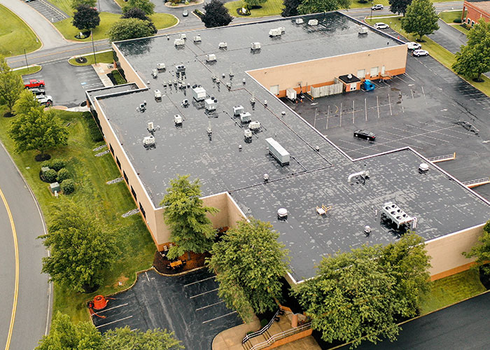 Aerial view of a commercial roof replacement in progress